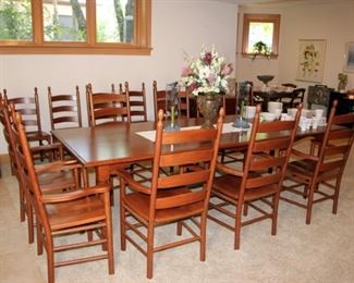 Spectacular Cherry Dining Table with 14 Chairs and Extension that Doubles as Drop Leaf Side Table.  There are 8 Captain's Chairs and 4 Side Chairs.  Amish Style Made in USA.