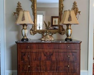 Beautiful Louis Philippe marble-topped 4-drawer walnut chest, antique French gilt wood mirror, flanked with a pair of Italian gilt wood double light wall sconces, pair of MOP/brass table lamps and vintage brass eagle on gilt wood base.