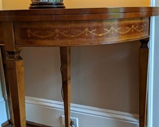 Detail of the inlaid wood on the demilune game table.