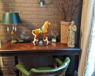 Antique English library/game table, with inlay, French bouillotte lamp, vintage green naugahyde armchair, vintage cast iron card holder and concrete St. Francis.