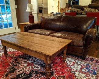 Nice vintage pine coffee table, atop a hand-woven Persian Heriz wool rug., measuring 7' 4" x 10' 6".