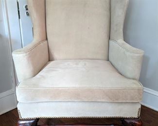 One of the pair of pigskin upholstered wingbacks, with brass nailhead trim.