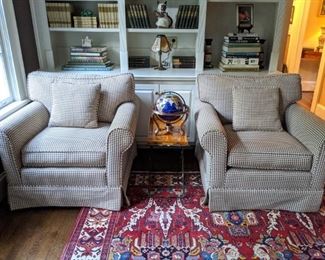 Pair of amazingly comfortable houndstooth upholstered armchairs, tole side table, gemstone globe and tons of books on the shelves behind.