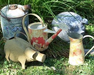 Watering cans, pitcher and concrete piglet