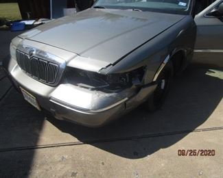 2000 Mercury Grand Marquis - Damage to headlight and bumper.  Will need new tire.  Rim in trunk.