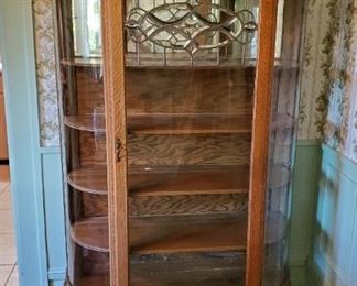 Curved glass oak china cabinet with lions on top
