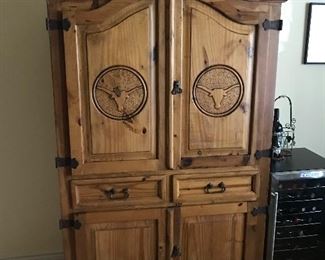 Rustic Texas cabinet with long horns on it 
