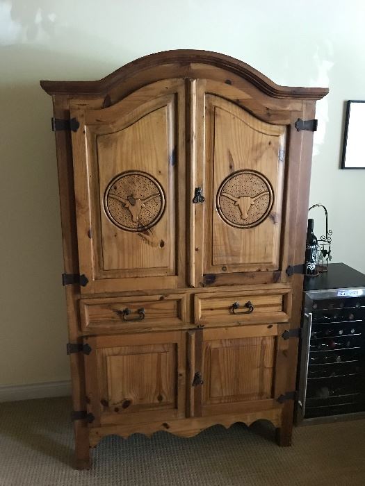 Rustic Texas cabinet with long horns on it 