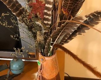 Leather vase with feathers