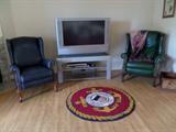 Leather wingback chairs; 42 inch HDTV; Glass and metal TV Stand; US Coast Guard area rug