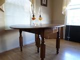 Antique drop leaf table and hurricane oil lamps