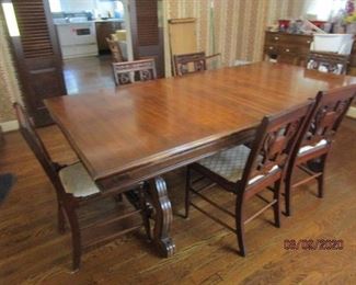 Vintage dining room table with one leaf in it plus another leaf and 6 chairs