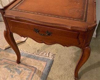 Wooden end table with leather inlaid top- right side of leather top  has worn area.   Wood is very nice Was  $90 now 40.$