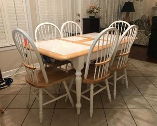 Breakfast table with one self-storing center leaf with 6 chairs