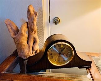 Mid century glass top sofa table, mantle clock, and drift wood.