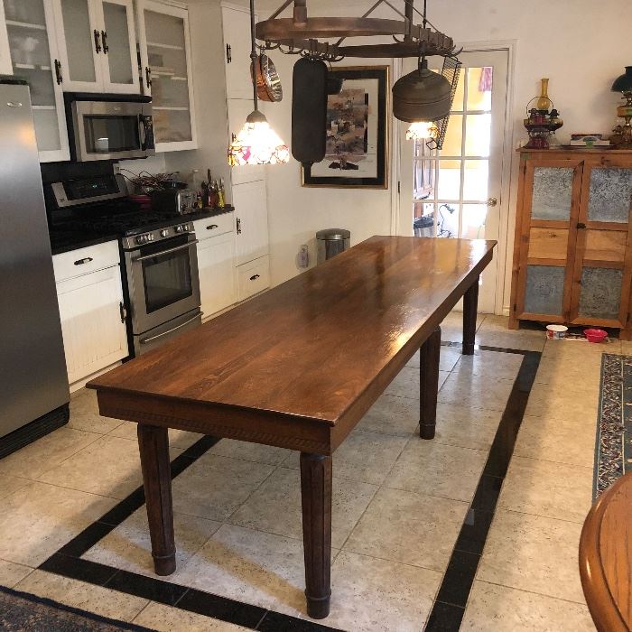 Vintage Library Table Converted to Farmhouse Table. 
This item was originally in a library then purchased to be converted into a harvest / farmhouse table for a dining area / kitchen. The table measures 10 feet in length, 34 inches across, and 30 inches in height. Table is in great condition and very sturdy.