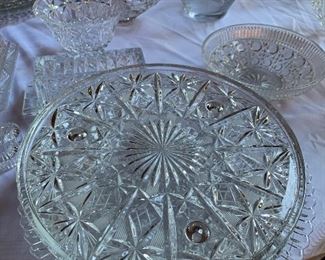 lots of crystal and glass cake plates and platters
