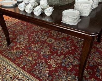 Dining room table with a large set of Noritake china and a Sunflower punch bowl.