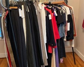 A nice rack of designer clothing in an assortment of sizes 
Armani, Ralph Lauren, Calvin Klein, and much more