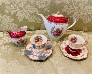 ITEM 54: ZEH SCHERZER DECORATED CUPS, SAUCERS, COFFEE/TEAPOT and CREAMER. Made in Germany. 