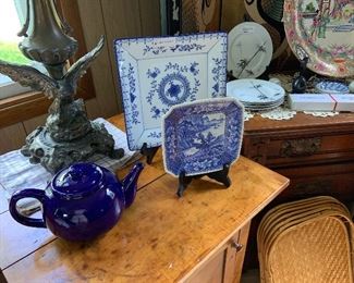 cast iron table lamp, blue teapot,blue and white plates, on side table
