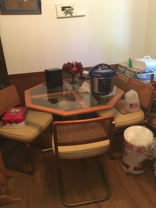 Kitchen table with wicker back chairs. Chair frame needs refinishing. 