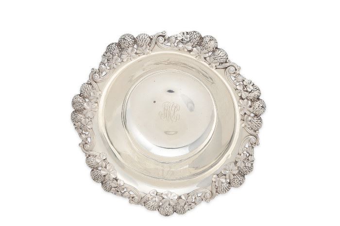 1
A Tiffany & Co. Sterling Silver Center Bowl
Circa 1891-1902
Stamped: Tiffany & Co / 13780 Makers 1802 / Sterling Silver / 925-1000; Further stamped for Charles L Tiffany: T; Personalized to center
The bowl with flower and clover leaf pattern to the rim
2.5" H x 10" Dia.
17.935 oz. troy approximately
Estimate: $800 - $1,200