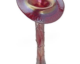 20
A Loetz Jack-In-The-Pulpit Style Iridescent Glass Vase
Late 19th/early-20th Century; Bohemia (Czech Republic)
The Art Nouveau vase in rare red glass with hand-applied threading
12.125" H x 5.875" W x 4" D
Estimate: $600 - $900