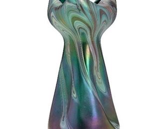 21
A Loetz Tri-Corner Iridescent Glass Vase
Late 19th/early-20th Century; Bohemia (Czech Republic)
The ribbon-style Art Nouveau vase in turquoise and red
9.125" H x 4.5" Dia.
Estimate: $600 - $900