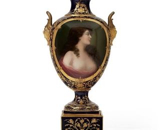 73
A Royal Vienna Portrait Vase
Late-19th/early-20th century
Signed to bottom: La Rose 7671; With blue overglaze mark for Royal Vienna
The pine cone finial over a cobalt blue and gilt-highlighted body flanked by grotesque masks enclosing a portrait of a scantily clad woman raised on a stepped pedestal base
23.75" H x 10.25" W x 8.25" D
Estimate: $2,000 - $3,000