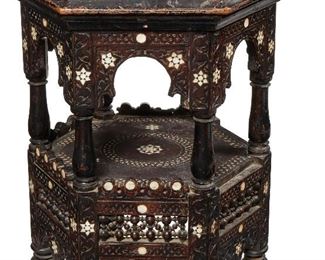 99
A Moroccan Carved Wood Side Table
Late-19th/early-20th Century
The hexagonal carved wood table with mother of pearl inlay, arch-shaped aprons, and undershelf
21" H x 17.5" Dia.
Estimate: $600 - $800