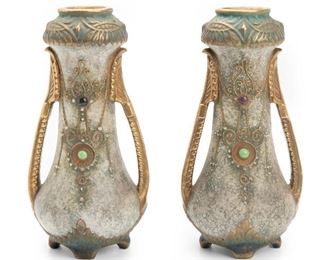 116
A Pair Of Amphora Vases
Circa1900; Austria
One marked indistinctly to base: Austria / Amphora / 11629; One further labeled with remnants of makers tag
Each two-handled Art Nouveau polychromed glazed ceramic vase with jeweled decoration and gilt details, 2 pieces
Each: 11" H x 5.5" W x 5" D
Estimate: $500 - $700