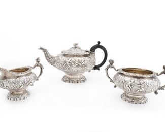 136
An English Sterling Silver Tea Service
Circa 1820s; London, England
Stamped for Joseph Craddock and William Reid / Sterling
Comprising a teapot, cream jug, and sugar bowl, each raised on a decorative foot with embossed foilate scrolls, putti, and flower heads, and a slightly domed, hinged lid with embossed decoration surmounted by a detachable flower and leaf sprig finial, the teapot with later-added wood C-scroll handle
Teapot: 6.25" H x 11.375" W x 7" D
58.2 gross oz. troy approximately
Estimate: $1,200 - $1,800