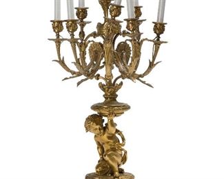 158
A French Seven-Light Gilt-Bronze Candelabra
Fourth-quarter 19th Century
Stamped: H. Picard
The figural candelabra featuring a child holding up a plinth issuing seven arms at various heights decorated with floral motifs seated on an elaborate base with scroll feet, converted to electric light
29.75" H x 15" W x 12" D
Estimate: $800 - $1,200
