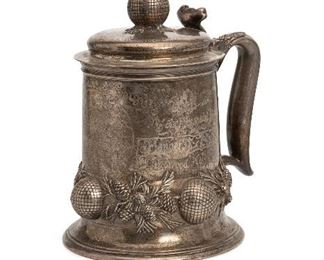 184
A Tiffany & Co. Sterling Silver Golf Presentation Tankard
Circa 1896-1897
Stamped to base: Tiffany & Co / 8435 Makers 6802 / Sterling Silver / 925-1000 / 5 Pints; Futher stamped for Charles L. Tiffany: T
The large lidded tankard with golf ball and pinecone design and embossed presentation: Mid-Winter Golf Tournament, Ocean County Hunt and Country Club, Open Handicap Cup presented by Mrs. George Jay Gould, January 1st, 1897, Thirty-six holes medal play won by Herbert I. Pratt, Lakewood, N.J.
10.5" H x 9.25" W x 7.375" D
58.280 oz. troy approximately
Estimate: $3,000 - $5,000