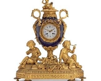 189
A French Gilt Bronze And Porcelain Mantle Clock
Second-half 19th Century
Bears signature to porcelain dial: Raingo Freres / A Paris; Further stamped to back: 281M
The clock set in a cobalt blue urn with bronze mounts surmounted by a cupid and globe finial over a porcelain face with Arabic and Roman numeral markers atop a footed base
22" H x 19.5" W x 8" D
Estimate: $4,000 - $6,000