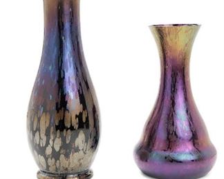 244
Two Loetz Iridescent Glass Vases
Late 19th/early-20th Century; Bohemia (Czech Republic)
Both vases in deep purple glass with applied iridescent purple and gold bubble pattern, the larger with black interior, 2 pieces
Taller: 11.125" H x 4.5" Dia.; Shorter: 8.375" H x 4.5" Dia.
Estimate: $500 - $700