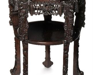 248
A Chinese Carved Side Table
Fourth-quarter 19th Century
The inset marble top over an ornately carved apron and legs depicting hummingbirds and flowers
31.5" H x 23" Dia.
Estimate: $800 - $1,200