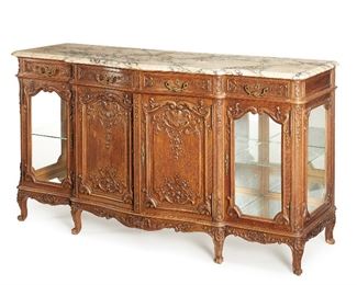 276
A French Louis XV-Style Credenza
Fourth-quarter 19th Century
The carved oak sideboard with marble top over four shallow drawers over a central cabinet with adjustable shelf and two glass side cabinets with adjustable fitted glass shelves each with brass handle and keyhole
43.5" H x 78" W x 26.5" D
Estimate: $2,000 - $3,000