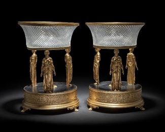280
A Pair Of Austrian Crystal And Bronze Compotes
Fourth-quarter 20th Century
Each stamped under base: Austria
Each circular bronze base with three Classical figures in open gallery holding a cut crystal bowl, 2 pieces
Each approximately: 14.25" H x 10" Dia.
Estimate: $1,500 - $2,500