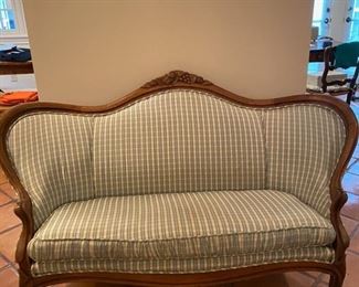 antique french love seat covered in blue and white silk 