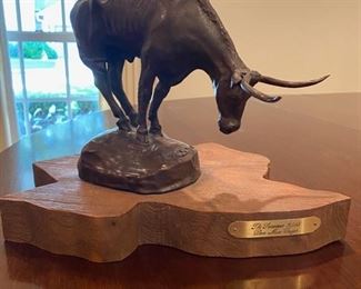 Bronze longhorn on a wood carved state of Texas by Don MacGregor