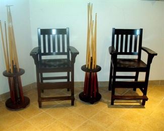 Spectator chairs & pool sticks with holders.