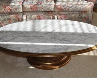 1960s Hollywood Regency Weiman Heirloom Quality gold leaf oval coffee table with footed wooden base and white granite top 56“ x 27” and 17” high