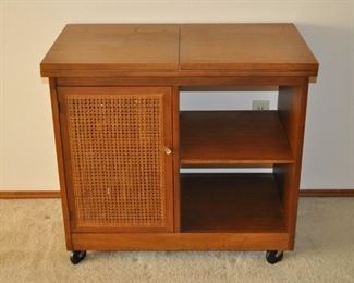 Mid-century server on wheels with woven cabinet door on one side and two shelves on the other side, 34” x 19” and 30” high (top flip opens to expand to 68” wide)
