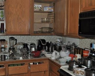 Baking dishes and supplies, cookbooks, Emeril stainless steel cookware, kitchen gadgets, Kitchenaid Ultra Power mixer new/newer, Keurig 2.0 K200 Plus, large marble cutting board, Magic Bullet cups and lids, marble mortar and pestle, marble rolling pin on stand, Oneida stainless steel tall pot with lid new, Osterizer blender, Pyrex sets of glass mixing bowls, Revere pots and pans vintage, set of clear mixing bowls marked France, Sharp Carousel microwave 1200w, Silit Germany vintage cookware set, Slice O Matic, small appliances, Sunbeam Mixmaster handheld, Sunbeam Osker, Turbo Chopper, various pots and pans
