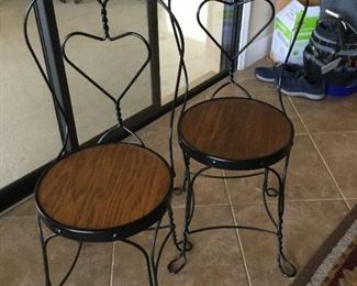 Set of 3 metal bistro chairs with wooden seats.