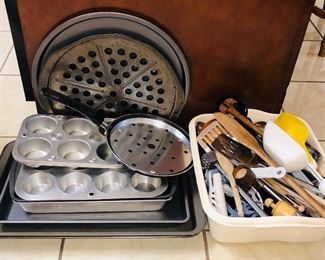 Assortment of baking sheets/ pans and utensils.