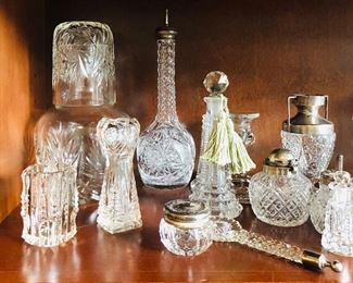 Antique cut glass- including tobacco jar with sterling band, telephone dialer, perfume bottles, desk and vanity items with sterling accents, crochet thread holder with sterling top, candle holders.