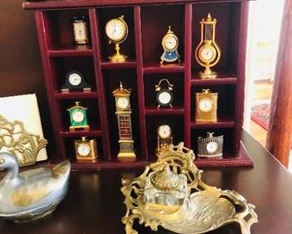 Complete set of Gorham  miniature brass clock in curio shelf.  Antique mother of pearl ink pen in original box.  Antique brass ink desk accessory.  